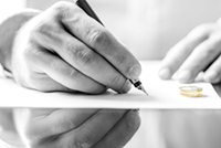 Image of man signing a document