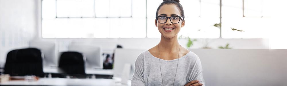 a smiley woman standing in an office